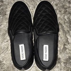 Steve Madden black slip ons.